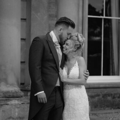Black and white photo of bride and groom embracing at Pendrall Hall Shropshire Wedding Photography