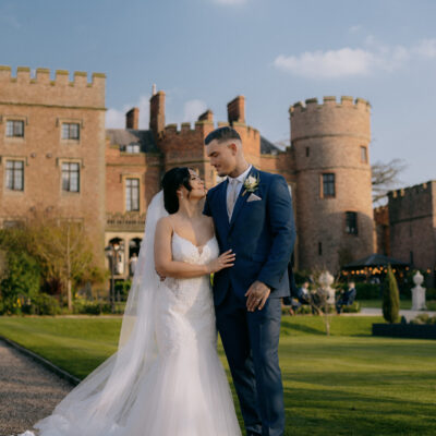 Bride and groom looking at each other in front of Rowton Castle Shropshire Wedding Photographer