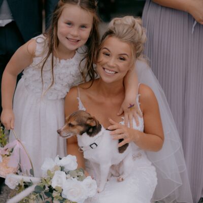 Bride with child and holding dog outside Pendrall Hall Shropshire Wedding Venue